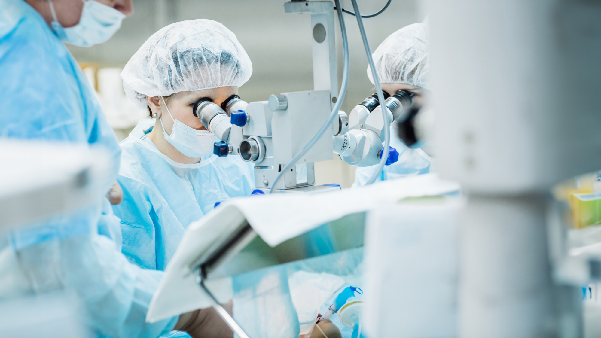 Opthalmology experts looking through microscopes